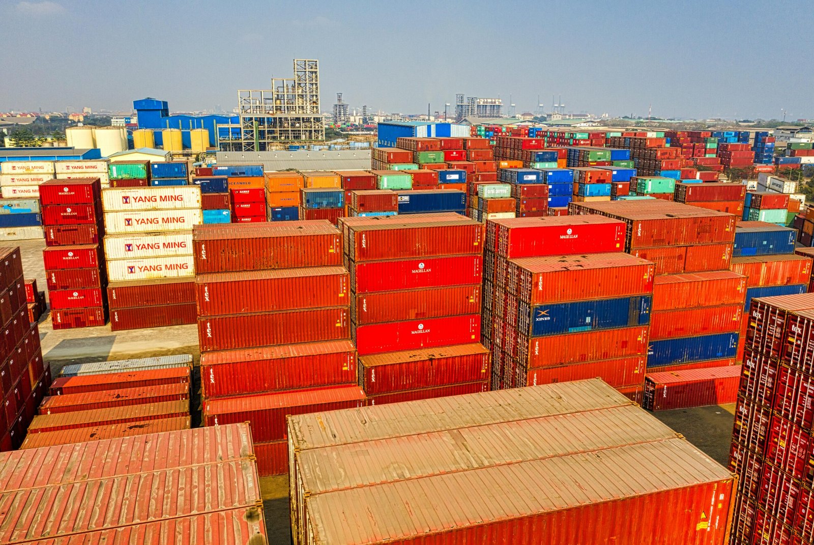 Drone shot showcasing stacked colorful cargo containers at Jakarta port.